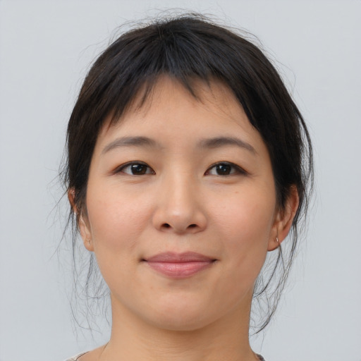 Joyful asian young-adult female with medium  brown hair and brown eyes