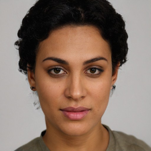 Joyful latino young-adult female with short  brown hair and brown eyes