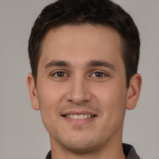 Joyful white young-adult male with short  brown hair and brown eyes