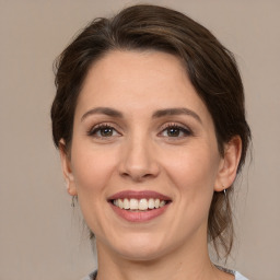 Joyful white adult female with medium  brown hair and brown eyes