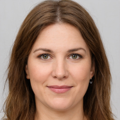 Joyful white young-adult female with long  brown hair and green eyes