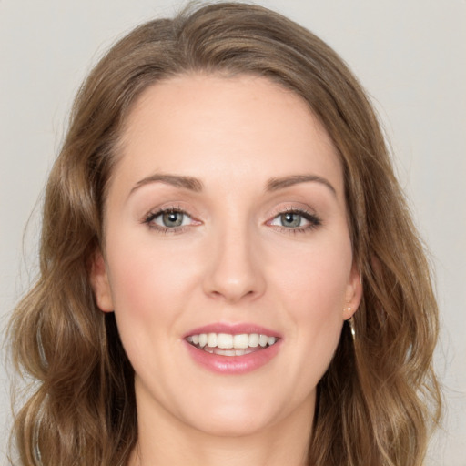 Joyful white young-adult female with long  brown hair and green eyes