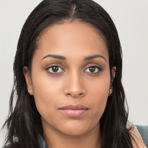 Joyful latino young-adult female with long  brown hair and brown eyes