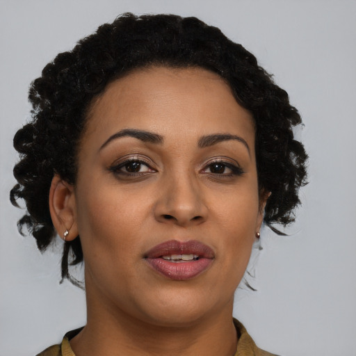 Joyful black young-adult female with short  brown hair and brown eyes