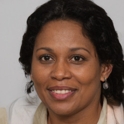 Joyful black adult female with medium  brown hair and brown eyes