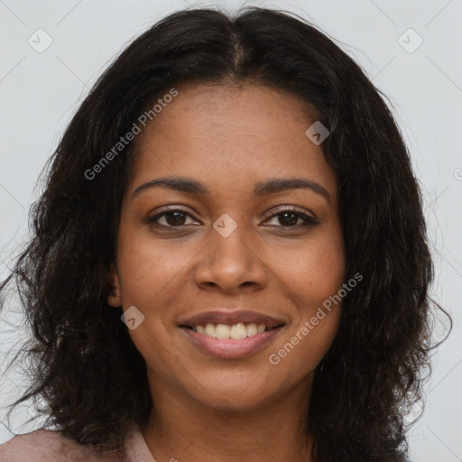 Joyful black young-adult female with long  brown hair and brown eyes