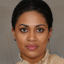 Joyful black young-adult female with medium  brown hair and brown eyes