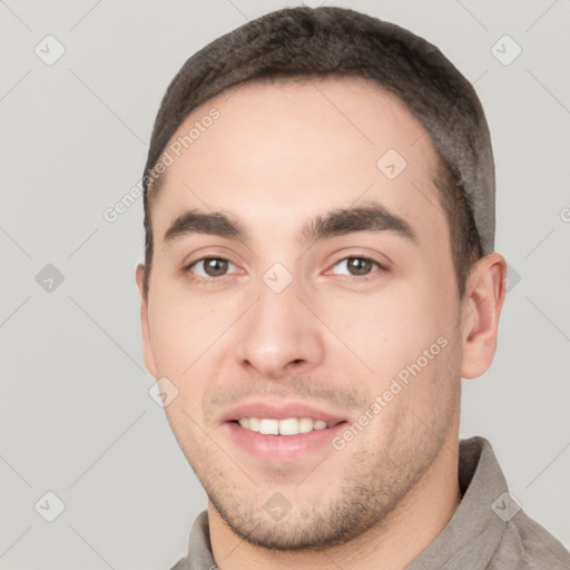 Joyful white young-adult male with short  black hair and brown eyes