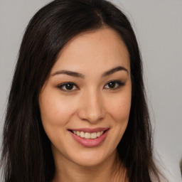 Joyful asian young-adult female with long  brown hair and brown eyes