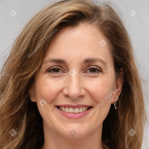 Joyful white adult female with long  brown hair and brown eyes