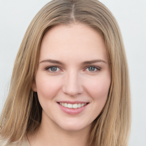 Joyful white young-adult female with long  brown hair and grey eyes