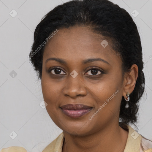Joyful black young-adult female with long  black hair and brown eyes