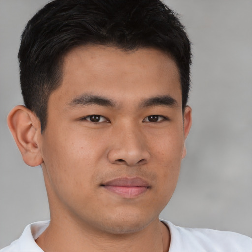 Joyful asian young-adult male with short  brown hair and brown eyes