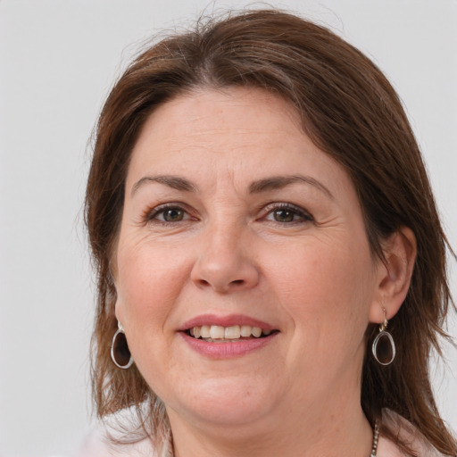 Joyful white adult female with medium  brown hair and brown eyes