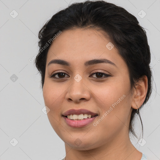 Joyful latino young-adult female with medium  brown hair and brown eyes