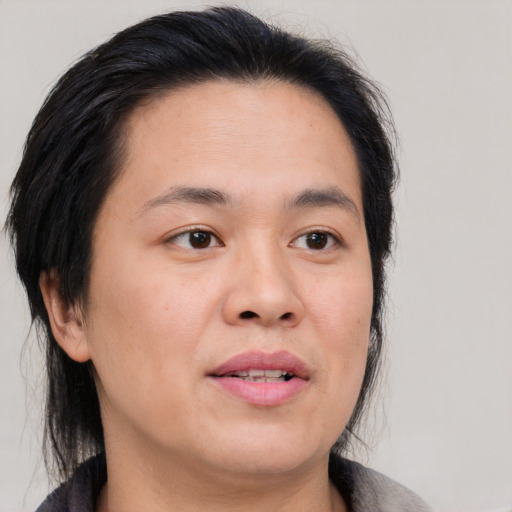 Joyful asian adult female with medium  brown hair and brown eyes