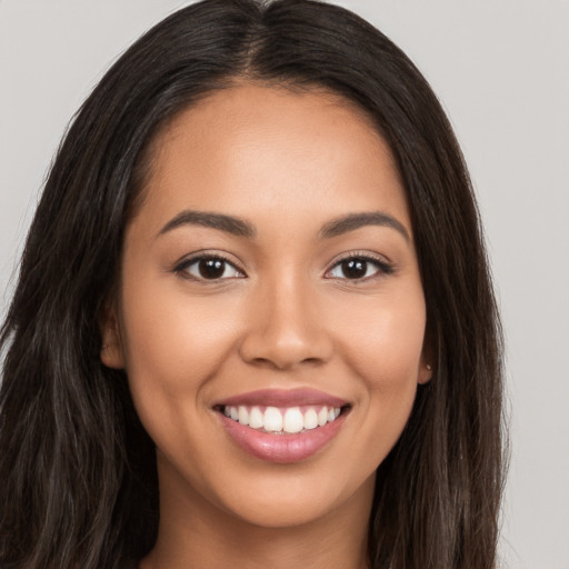 Joyful white young-adult female with long  brown hair and brown eyes