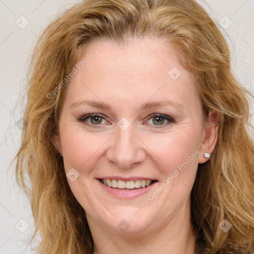 Joyful white young-adult female with long  brown hair and green eyes