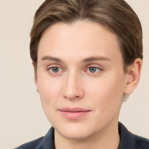 Joyful white young-adult female with short  brown hair and grey eyes