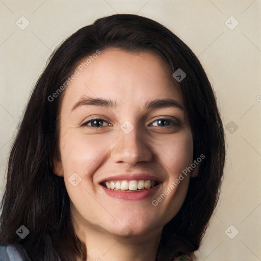Joyful white young-adult female with long  black hair and brown eyes