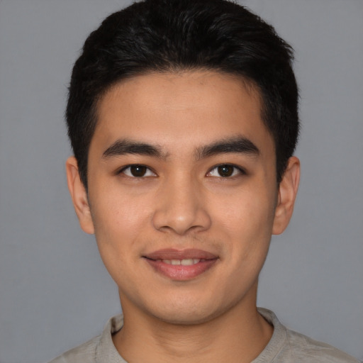 Joyful latino young-adult male with short  black hair and brown eyes