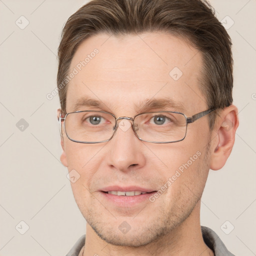 Joyful white adult male with short  brown hair and grey eyes