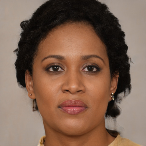 Joyful black young-adult female with medium  brown hair and brown eyes