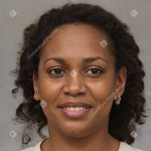 Joyful black adult female with medium  brown hair and brown eyes