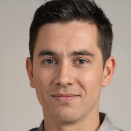 Joyful white young-adult male with short  brown hair and brown eyes