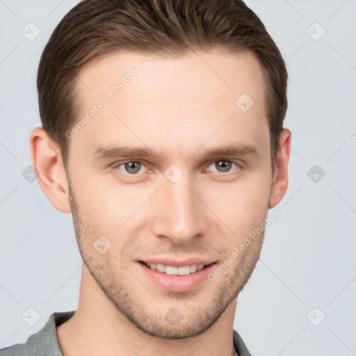 Joyful white young-adult male with short  brown hair and grey eyes