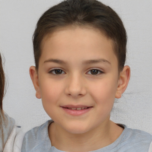 Joyful white child female with short  brown hair and brown eyes