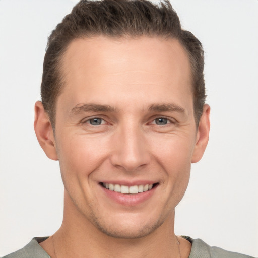 Joyful white young-adult male with short  brown hair and brown eyes