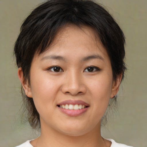 Joyful asian young-adult female with medium  brown hair and brown eyes