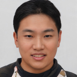 Joyful asian young-adult male with short  black hair and brown eyes