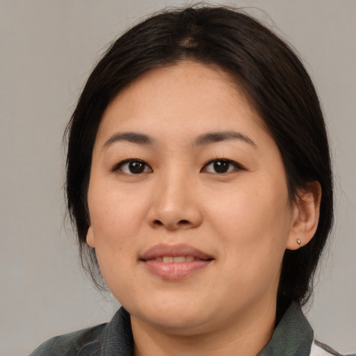 Joyful asian young-adult female with medium  brown hair and brown eyes