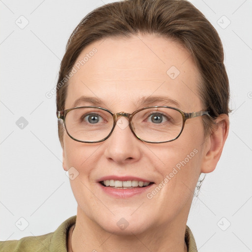 Joyful white adult female with short  brown hair and grey eyes