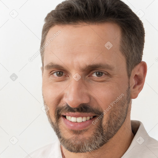 Joyful white adult male with short  brown hair and brown eyes