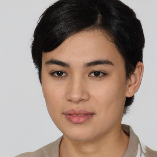 Joyful latino young-adult female with short  brown hair and brown eyes