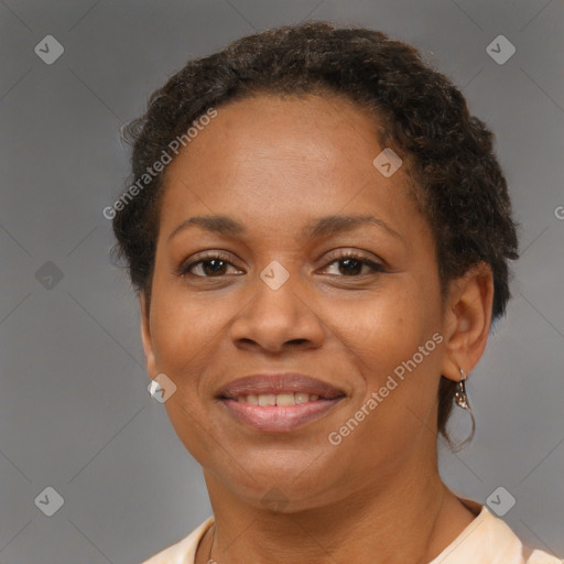 Joyful black adult female with short  brown hair and brown eyes