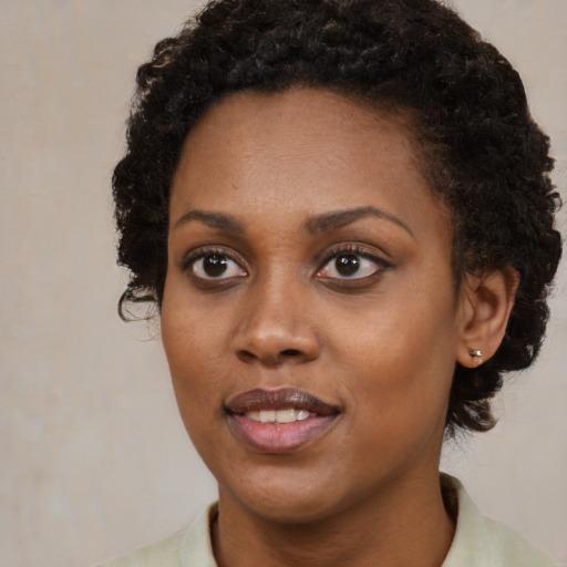 Joyful black young-adult female with medium  brown hair and brown eyes