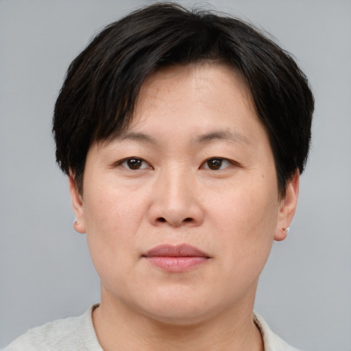Joyful asian adult male with short  brown hair and brown eyes