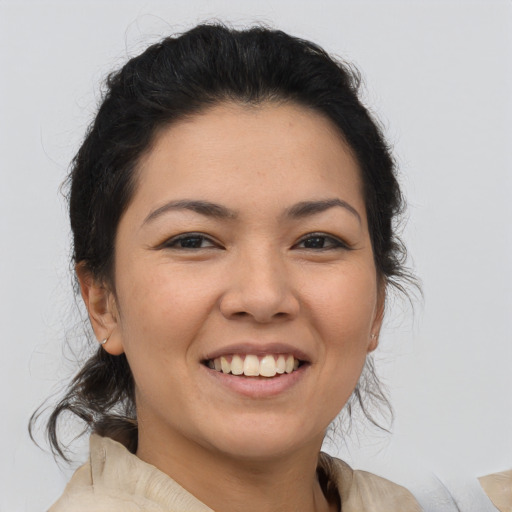 Joyful asian young-adult female with medium  brown hair and brown eyes