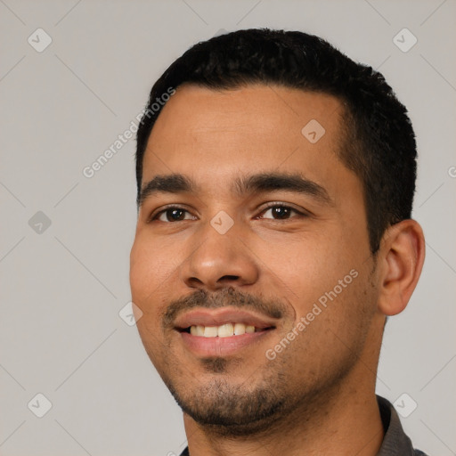 Joyful latino young-adult male with short  black hair and brown eyes