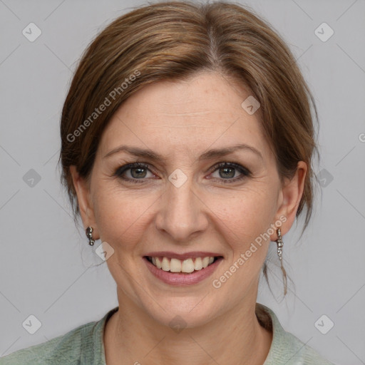 Joyful white adult female with medium  brown hair and grey eyes