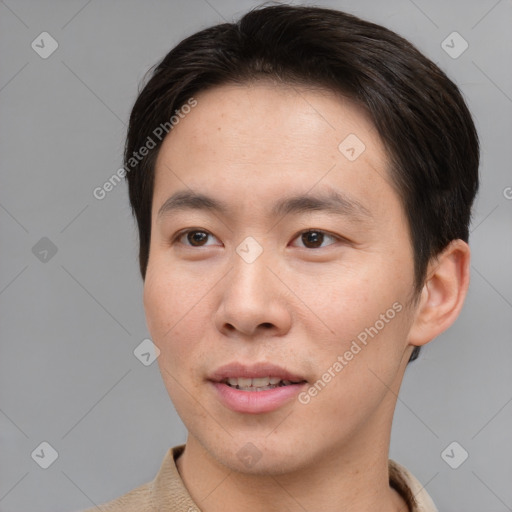 Joyful asian young-adult male with short  brown hair and brown eyes