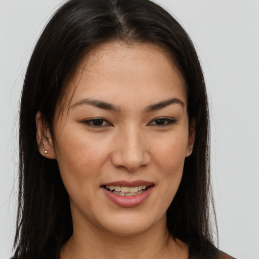 Joyful asian young-adult female with long  brown hair and brown eyes