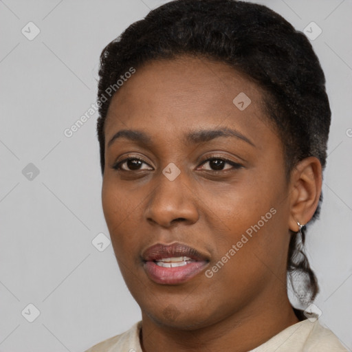 Joyful black young-adult female with short  black hair and brown eyes