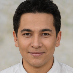 Joyful latino young-adult male with short  brown hair and brown eyes