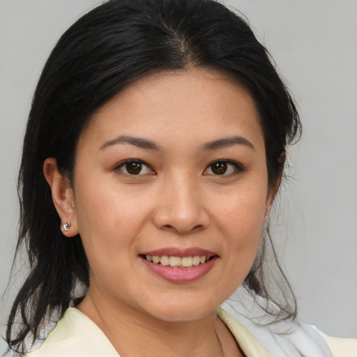 Joyful asian young-adult female with medium  brown hair and brown eyes