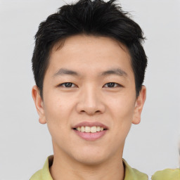 Joyful asian young-adult male with short  brown hair and brown eyes